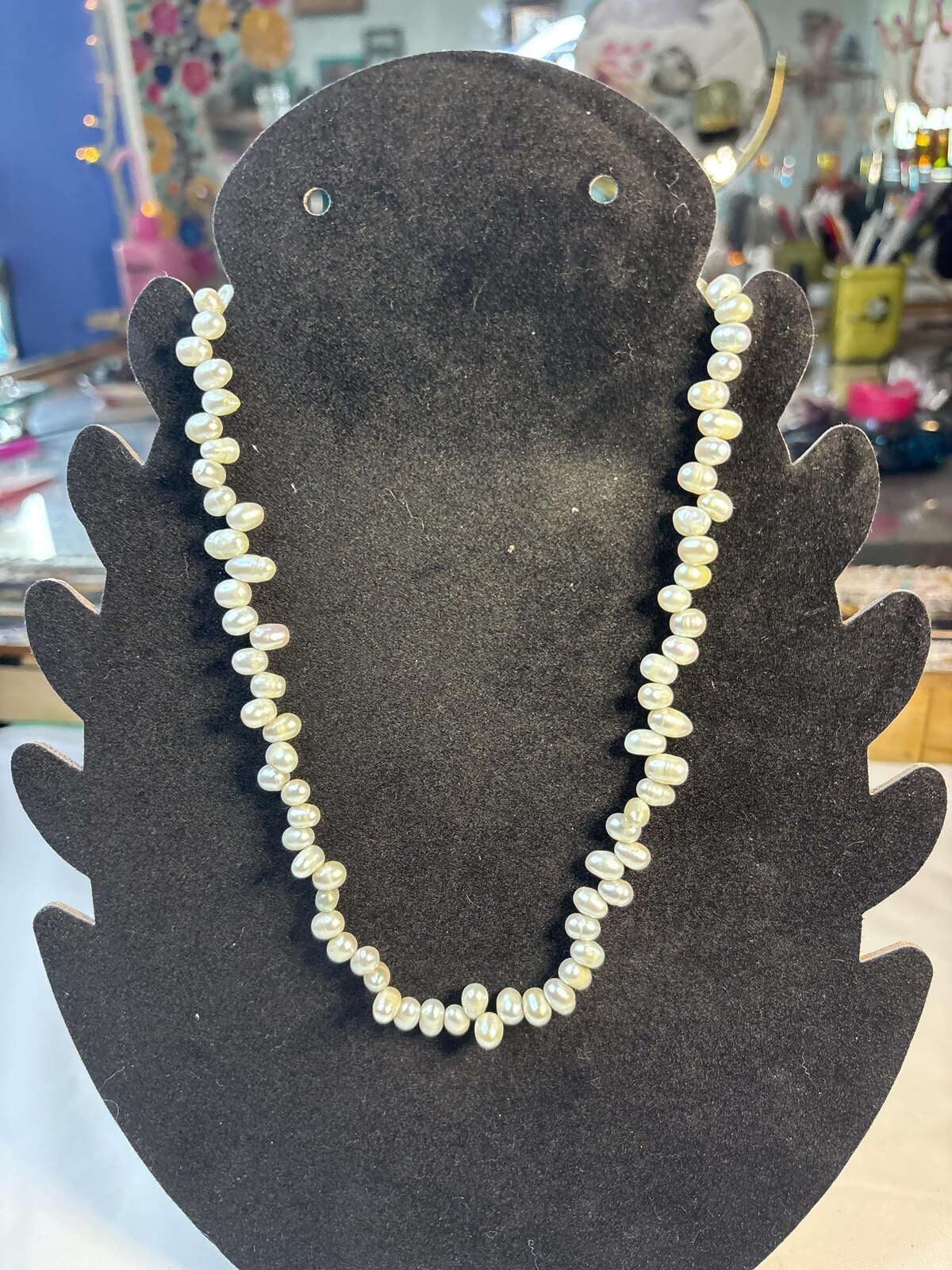 Pearl 17 inch necklace on a black display bust
